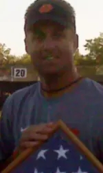 Mike Gundy with the American flag presented to the OSU football team by Army Sgt. Michael Heimdale.