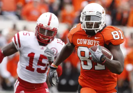 Oklahoma State wide receiver Justin Blackmon, right, carries a Brandon Weeden pass into the endzone for a touchdown as Nebraska defender Alfonzo Denard, left, gives chase, in the second quarter of an NCAA college football game in Stillwater, Okla., Saturday, Oct. 23, 2010. (AP Photo/Sue Ogrocki)