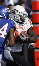 Running back Kendall Hunter (24) is forced out-of-bounds by Kansas safety Taylor Lee (24) during the first half. (AP Photo/Orlin Wagner)