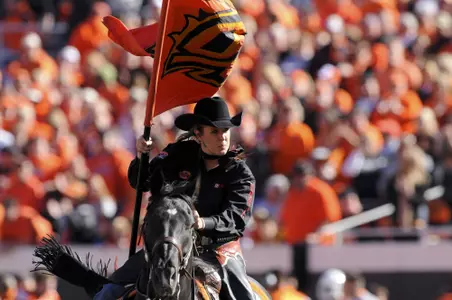 Oklahoma State spirit rider Laine Croft rides Bullet across the football field after an Oklahoma State touchdown.