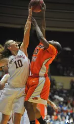 Oklahoma forward Carlee Roethlisberger (10) blocks a shot from Oklahoma State guard Andrea Riley in the first half. (AP Photo/Denny Medley)