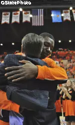 Obi Muonelo hugs coach Travis Ford prior to Senior Day on Saturday.