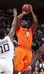 Matt Pilgrim shoots for two points over David Loubeau Wednesday night in College Station.