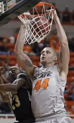 Philip Jurick dunks in front of Arkansas-Pine Bluff guard Savalace Townsend. Jurick had seven points, 10 rebounds and five blocks.