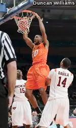 Michael Cobbins dunks over a couple of Virginia Tech players in Madison Square Garden.