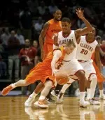 Oklahoma State's Keiton Page drives the ball as Alabama forward Nick Jacobs defend. (AP Photo/Robert Sutton)