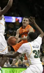 Oklahoma State guard Cezar Guerrero, center, feeds a pass through Baylor' Deuce Bello and Quincy Miller. (AP Photo/Tony Gutierrez)