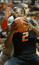 Le'Bryan Nash pivots around a Virginia Tech forward to attempt a shot.