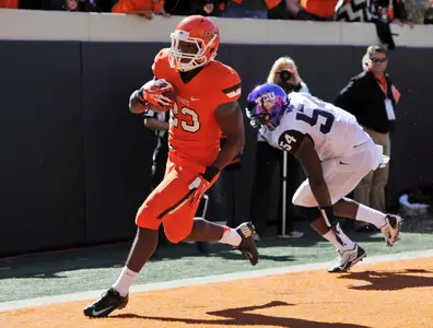 Oct 19, 2013; Stillwater, OK, USA; Oklahoma State Cowboys running back Rennie Childs (23) rushes in past Texas Christian Horned Frogs linebacker Marcus Mallet (54) for a seven yard touchdown during the second half at Boone Pickens Stadium. Oklahoma State won 24-10. Mandatory Credit: Peter G. Aiken-USA TODAY Sports
