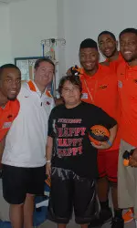 OSU's Cowboys visit with one of the children at St. Francis hospital.