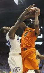 Forward Brian Williams drives to the basket against Jayhawks guard Andrew Wiggins.