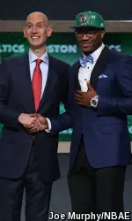 Marcus Smart shakes hands with the new commissioner of the National Basketball Association, Adam Silver.