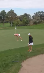 Maddie McCrary collects her ball after making a double eagle at the ninth