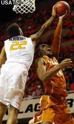 Jeff Newberry blocks the shot of Texas Longhorns forward Jonathan Holmes.