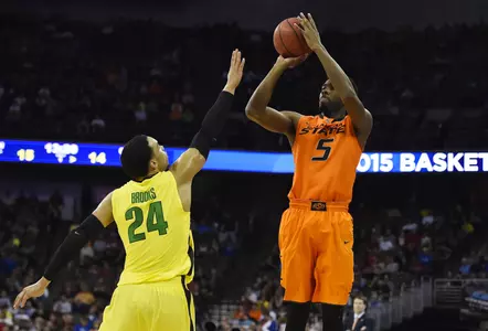 Oklahoma State Cowboys guard/forward Tavarius Shine (5) shoots over Oregon Ducks forward Dillon Brooks (24) during the first half in the second round of the 2015 NCAA Tournament at CenturyLink Center. Mandatory Credit: Jasen Vinlove-USA TODAY Sports