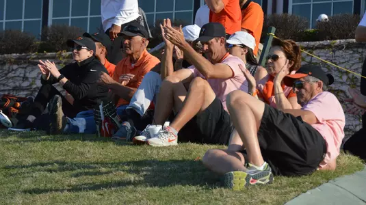 Jason Elmquist/Stillwater News Press Oklahoma State fans and players cheer for the Cowboys above the ninth green Monday at Southern Hills Country Club.