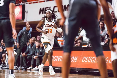 Isaac Likekele dribbles ball up the court