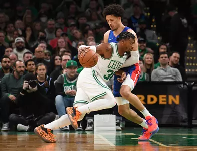 Cade Cunningham guards Marcus Smart In NBA Basketball Game
