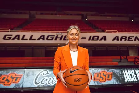 Oklahoma State head coach Jacie Hoyt Holds Basketball