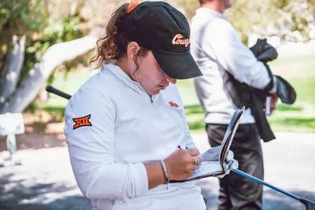 Hailey Jones checks card at Pebble Beach