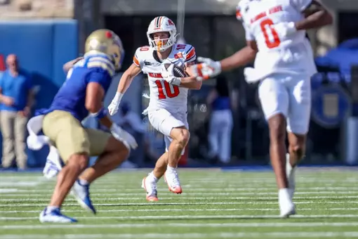 Oklahoma State wide receiver Wyatt Young eludes a tackler from Tulsa