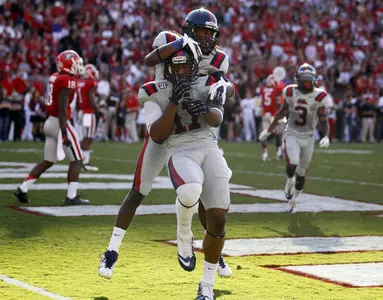 Jamal Mosley and Ja-Mes Logan celebrate a first-half touchdown (AP photo).