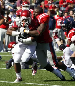 A helmet-less Joel Kite making a tackle in the 2011 meeting (AP Photo).
