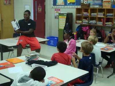 Williams reads to an elementary school class.