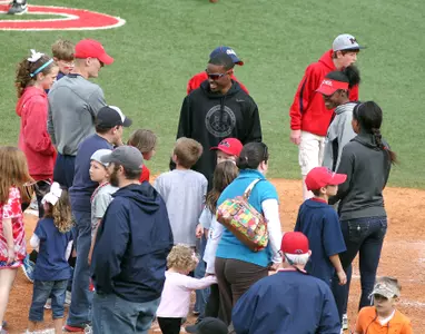 Isiah Young visits with young Rebel fans after a baseball game. (photo by Joshua McCoy)