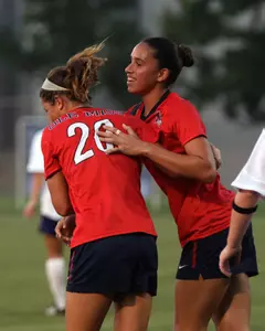 Rafaelle Souza (right) scored a pair of goals Sunday night to help the Rebels to the 3-0 win.