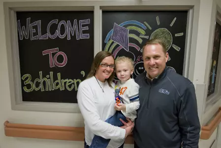 Hugh Freeze with Batson Children's Hospital patient Brody Bequette and his mother, Crystal Davis