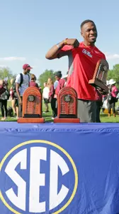 Ricky Robertson holds his SEC Commissioner's trophy (photo by Joey Jones)