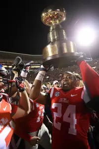Keith Lewis hoists the Golden Egg trophy after the win over Mississippi State. (photo by Joshua McCoy)