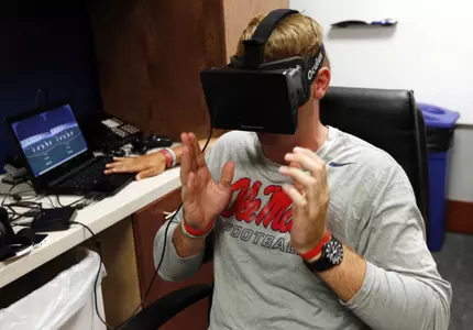 Ryan Buchanan uses a virtual reality headset. (AP Photo/Rogelio V. Solis)