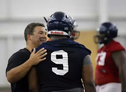 Defensive line coach Chris Kiffin and Breeland Speaks (photo by Joshua McCoy)