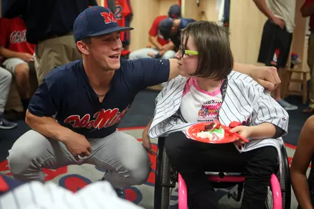 Courtney Dearing (right) shares a smile with Ole Miss freshman Cooper Johnson (left) during her surprise birthday party at Swayze Field.
