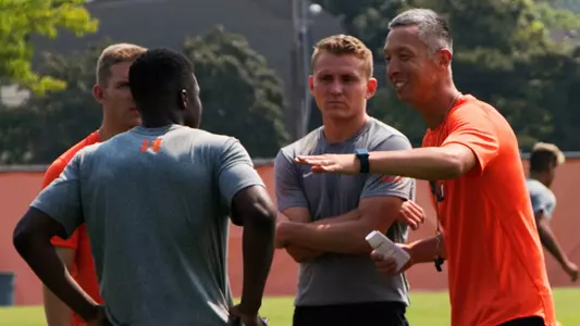 Coaches Simmons and Stoddard meet with players