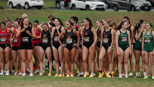 The cross country team stands on the start line, waiting to compete