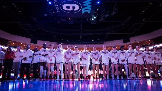 Team standing arm in arm before playing Portland in the WCC Tournament
