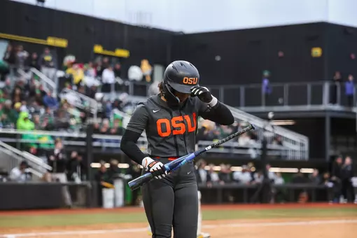 Mya Harrison grabbing her helmet as she walks back to the dugout.