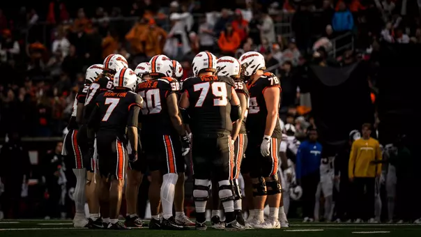 The Beavers huddle before a play at Reser Stadium