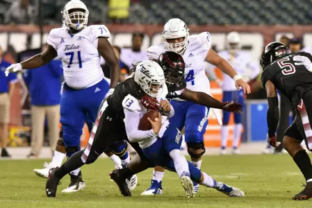 Tulsa Golden Hurricane quarterback LUKE SKIPPER (13) is tackled by Temple Owls defensive tackle FREDDIE BOOTH-LLOYD (99) causing a fumble during the American Athletic Conference football game played at Lincoln Financial Field in Philadelphia. Temple beat Tulsa 31-17.