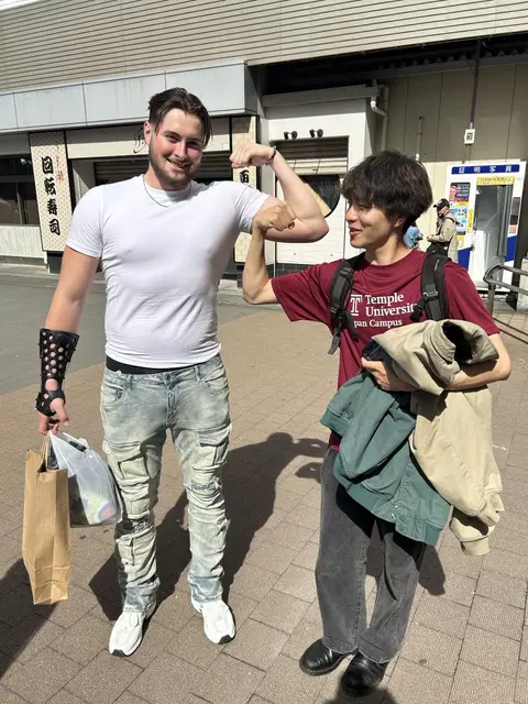 Peter Clarke flexing with a Temple Japan student.