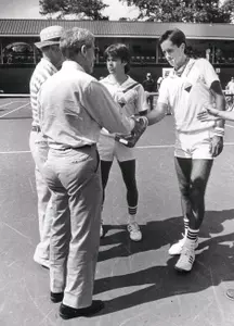 Kelly Jones (right) and Carlos DiLaura (left) accept trophy in Athens, Ga. after winning the 1985 NCAA Doubles Championship.