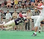 Mark Ponko blocks a<br>punt in the second<br>quarter, leading to a<br>Nick Lotz field goal.