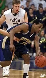 Jeremy Holmes heads upcourt after stealing the ball from the Irish as Troy Murphy gives chase during the first half of the 81-66 Panther loss Saturday.