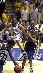 West Virginia's Chris Moss and Pittsburgh's Isaac Hawkins look on as Pittsburgh's Brandin Knight handles the ball in the first half in Morgantown, W.Va., Thursday.