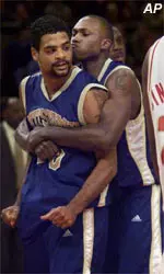 Pittsburgh's Ricardo Greer, left, gets a hug from teammate Jaron Brown during their game against Boston College in the the Big East Championship Saturday.