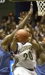 Brandin Knight is fouled by Georgetown's Courtland Freeman, left, as he shoots in the second half, Saturday.
