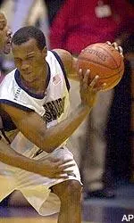 Brandin Knight keeps the ball away from a St. John's defender during first half.